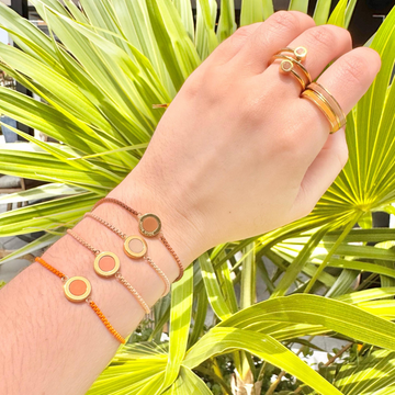 Jason Hyde's collection of colorful cord bracelets and gold rings