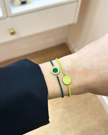Close-up of a wrist wearing two Jason Hyde cord bracelets