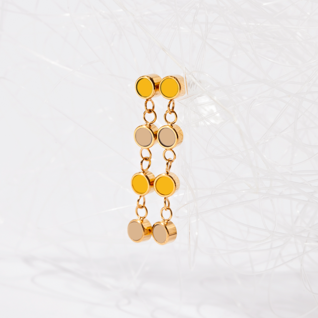 Fashionable gold earrings with layered beige and yellow enamel details