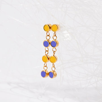 Long gold earrings with yellow and blue enamel charms from Jason Hyde.
