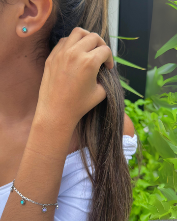 Close-up of a person's ear and arm, showcasing Jason Hyde silver-tone jewelry.
