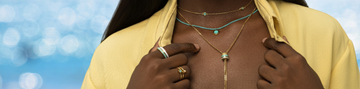 Close-up of a person wearing gold and turquoise jewelry