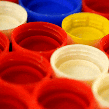GIF of red plastic bottle caps for recycling