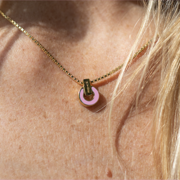 Elegant gold necklace with fondant pink detail by Jason Hyde.