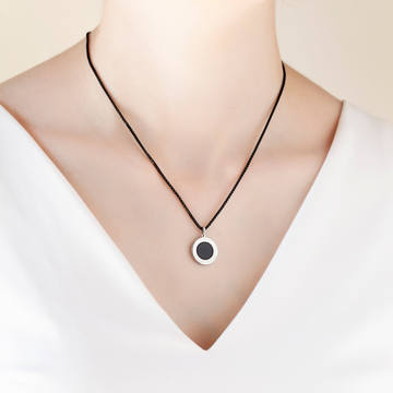 Close-up of a Jason Hyde necklace featuring a sustainable black chip pendant