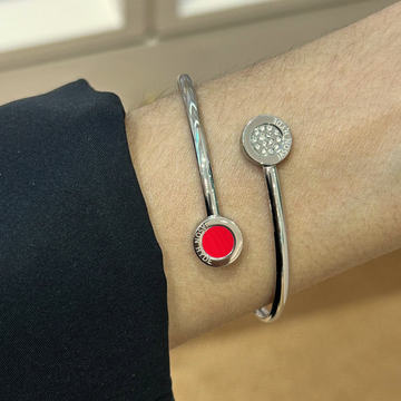 Pave bangle with red sustainable charm.