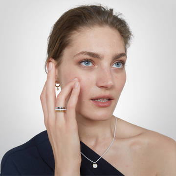 Woman showcasing modern Jason Hyde jewelry.