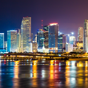 Miami skyline at night with reflections over the water
