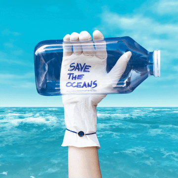 GIF: Hand holding "SAVE THE OCEANS" bottle over moving ocean waves