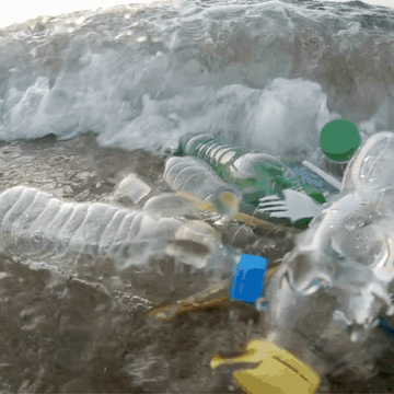 Gif of an ocean wave with plastic waste