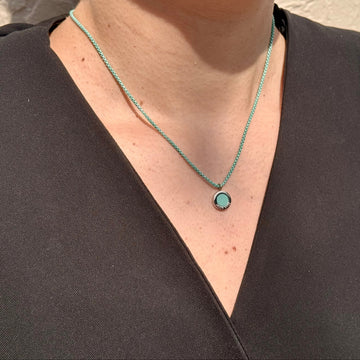 Close-up of a painted brass turquoise necklace