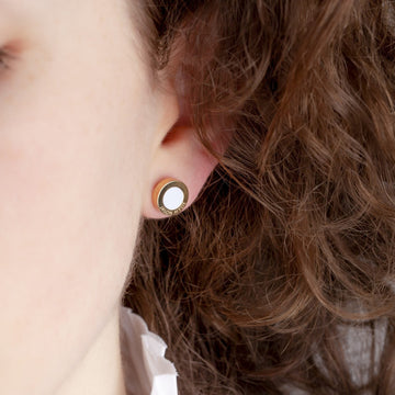 A detailed view of a person's earlobe featuring a Jason Hyde Ocean Earring