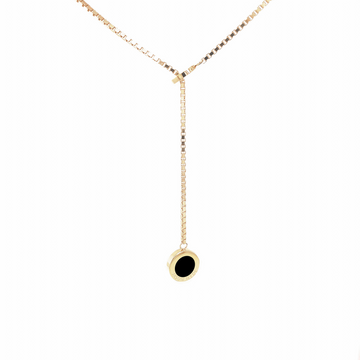 Gold necklace with a black chip pendant.