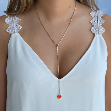 Sustainable gold lariat necklace with vibrant red recycled ocean plastic chip pendant