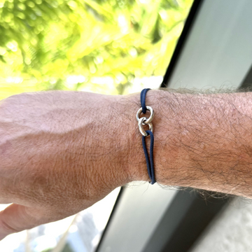 Jason Hyde Sayna Cord navy blue bracelet with silver charms worn on wrist