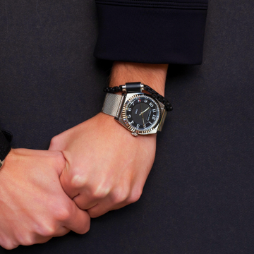 Jason Hyde watch and black braided bracelet on a wrist.