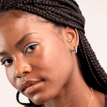 Portrait of a woman, showcasing a Jason Hyde small hoop earring in her ear