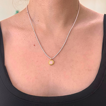 Jason Hyde necklace with a pink and gold-tone round pendant.