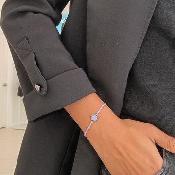 Close-up of Jason Hyde lavender bracelet featuring a delicate circular pendant