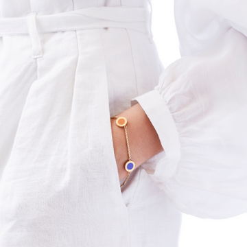 Gold chain bracelet with apricot crush and persian blue enamel circle pendants