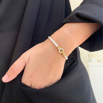 Jason Hyde Nereida white cord bracelet with gold clasp.