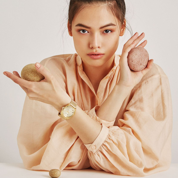 Sustainable gold wristwatch by Jason Hyde with mesh band, styled on woman