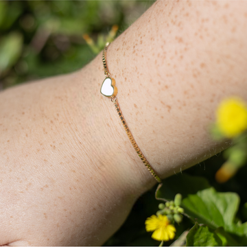 Sustainable gold bracelet with white heart detail, Jason Hyde