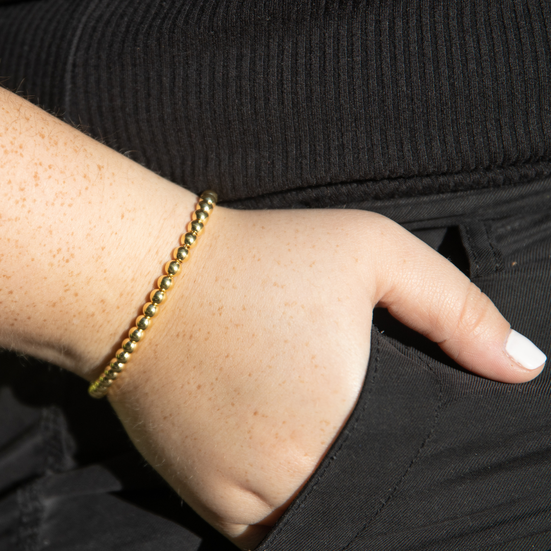 Jason Hyde gold beaded bracelet on wrist, 'ITALY HALF PALLINE' 3mm