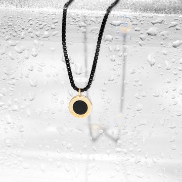 Jason Hyde Necklace with a black and gold pendant.
