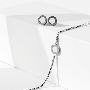 Silver Jason Hyde bracelet and chip earring set on a white display.