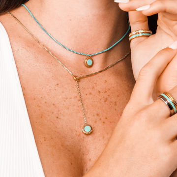 Turquoise lariat and ocean necklaces on woman's neck