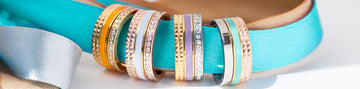 A panoramic shot displaying a collection of stylish rings with colorful enamel