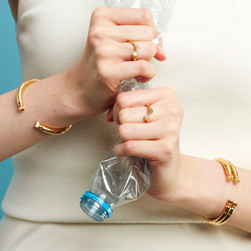 Gold rings and bracelets with a plastic bottle.