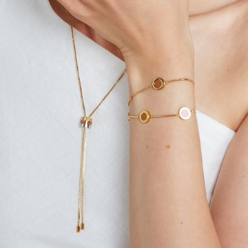 Gold-plated Bolo Tie Necklace, styled with Ocean Bracelets in nutshell tones.