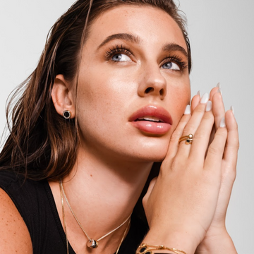 Woman modeling Jason Hyde ring, earring, and necklace