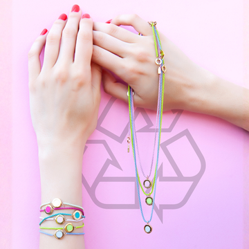Sustainable gold jewelry with colorful round pendants and matching layered chain bracelets
