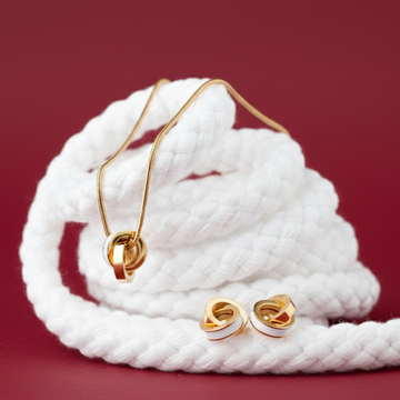 Gold interlocking ring pendant necklace and matching white enamel hoop earrings