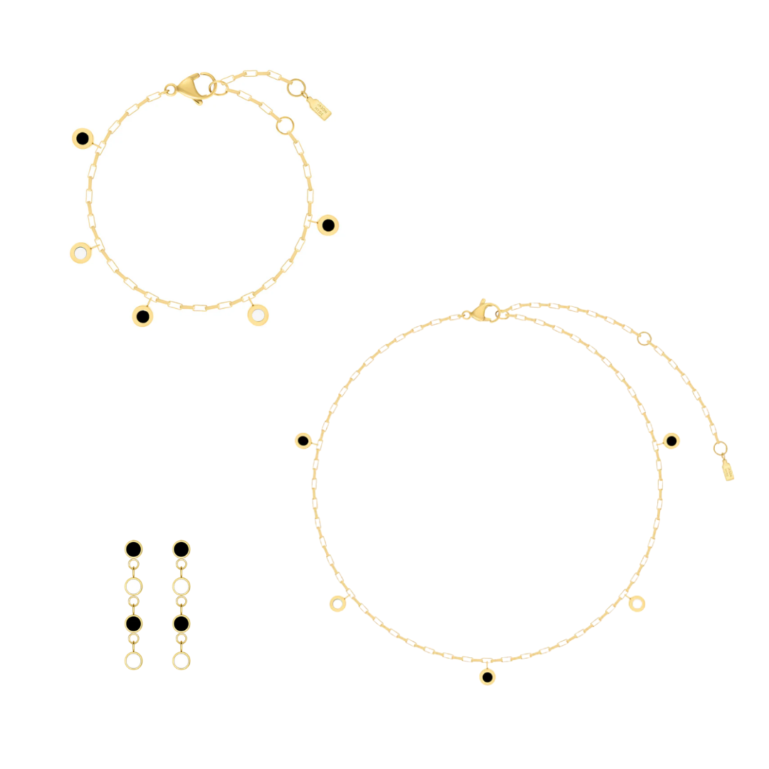 Gold Jason Hyde jewelry set with minimalist black and white details.