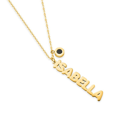 Gold Aquaname necklace with "ISABELLA" spelled vertically and a small black charm.