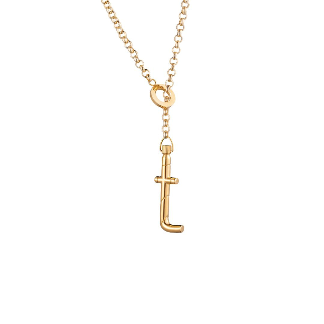 A gold lariat necklace with a polished lowercase 't' letter pendant 