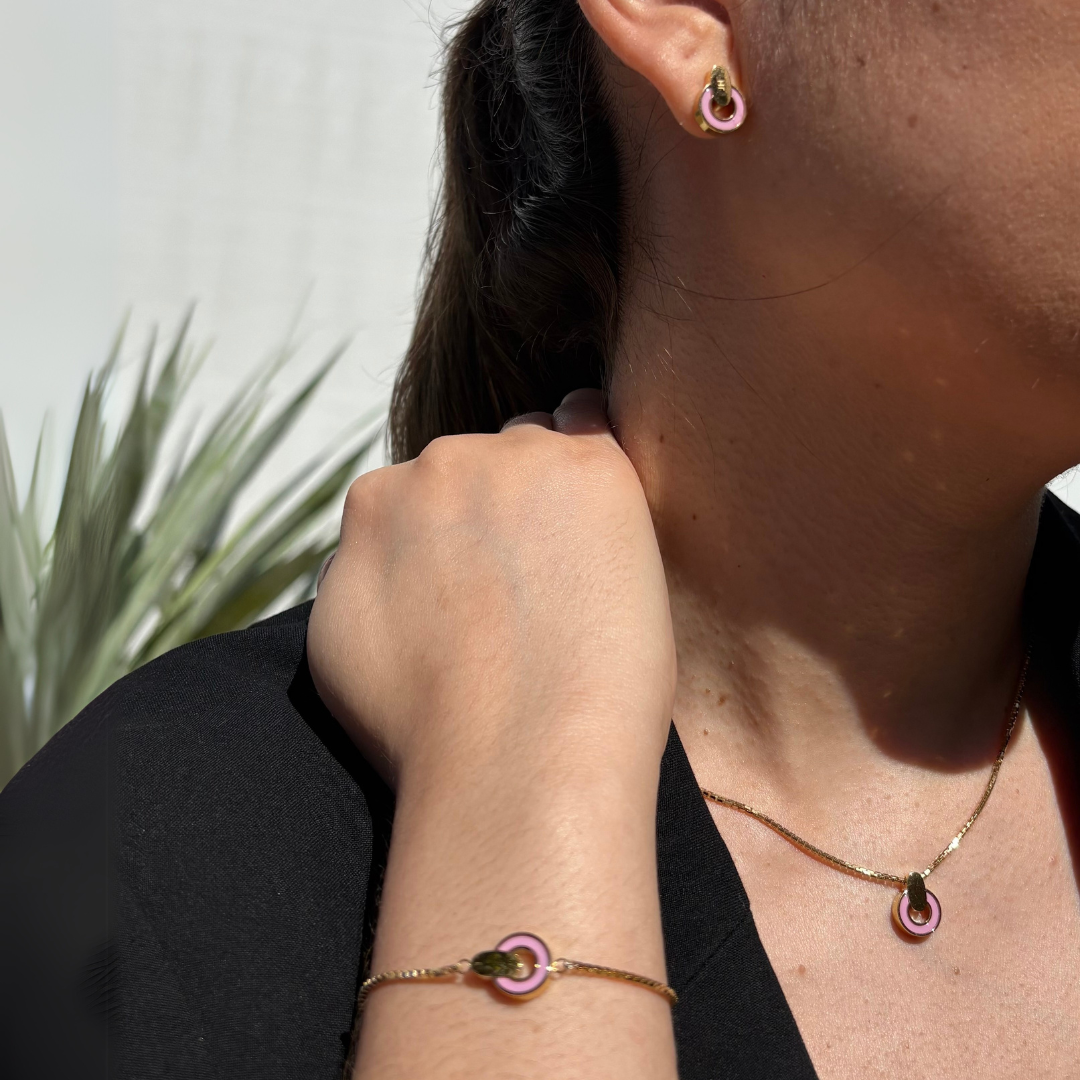 Gold earrings and bracelet with pink charms