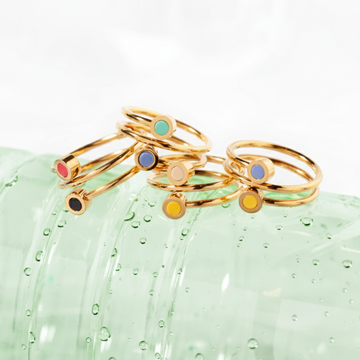 Stack of gold double-band rings with small colorful enamel dots 