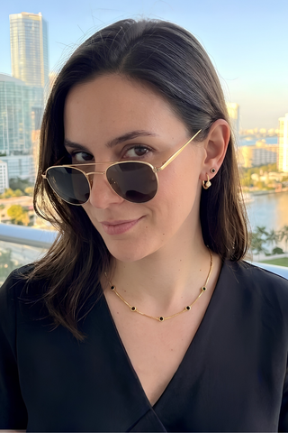extra-img-Model wears Jason Hyde black and gold charm necklace, and earrings.