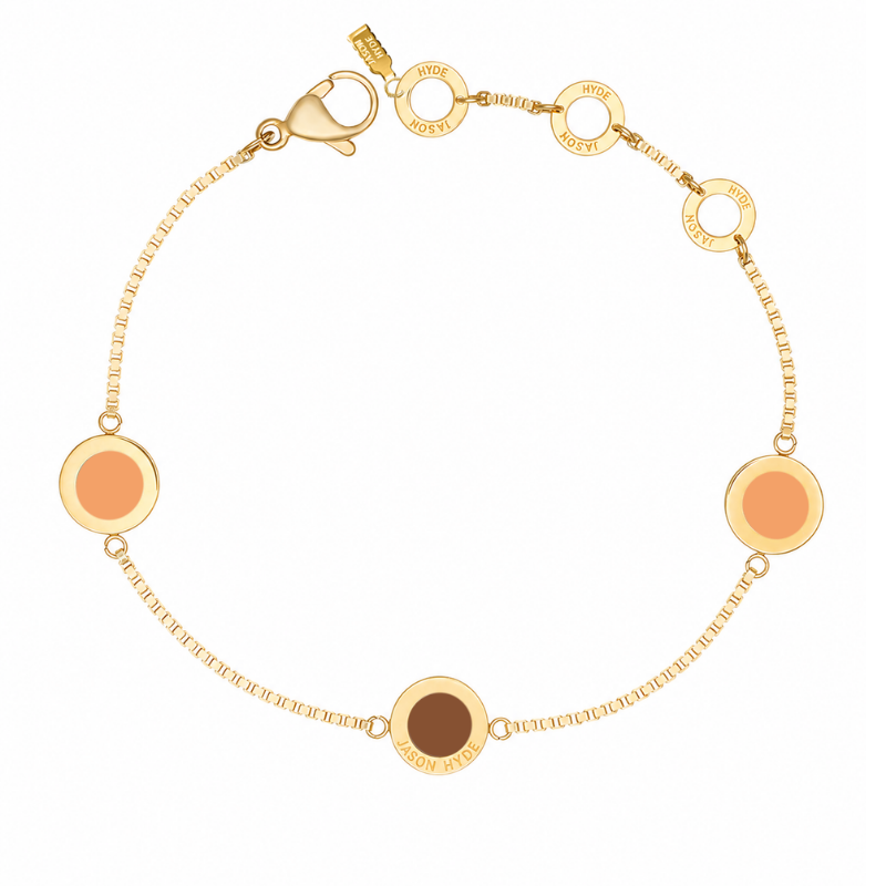 Gold-tone chain bracelet with two circular charms in "Apricot Crush" and a walnut-colored charm.