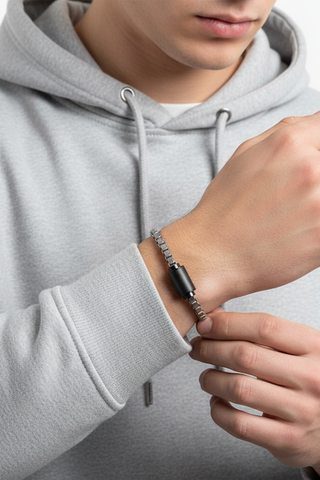 img-banner-Man wearing a minimalist silver box chain bracelet with a black magnetic matte clasp and a grey hoodie