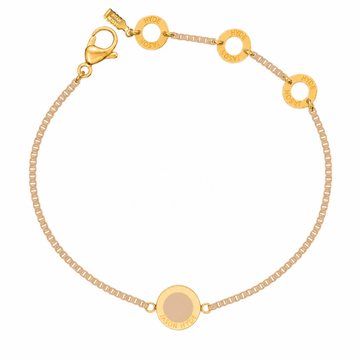 Beige chain bracelet with a matching circular enamel charm