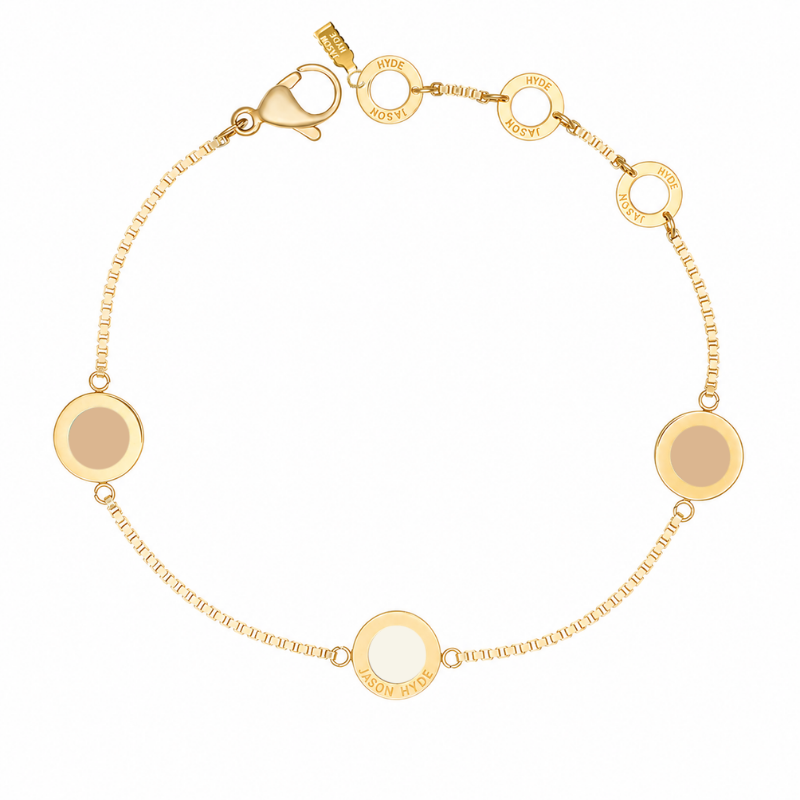 Gold box-chain bracelet featuring round beige and cappuccino charms