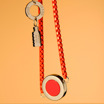 Jason Hyde red chain necklace with a circle pendant.
