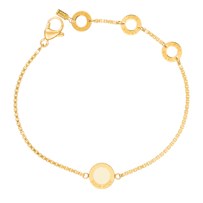 Cappuccino circular charm on a gold box chain bracelet by Jason Hyde.