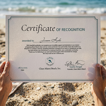 Hands holding a Clean Miami Beach Certificate of Recognition awarded to Jason Hyde